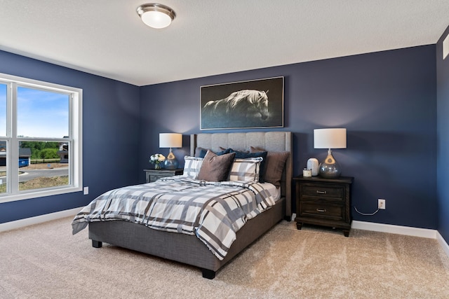 carpeted bedroom featuring baseboards