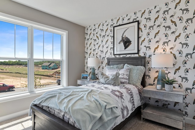 carpeted bedroom featuring baseboards and wallpapered walls