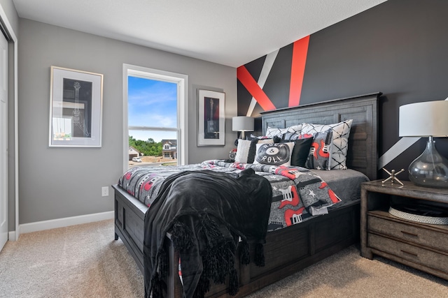 bedroom featuring carpet and baseboards