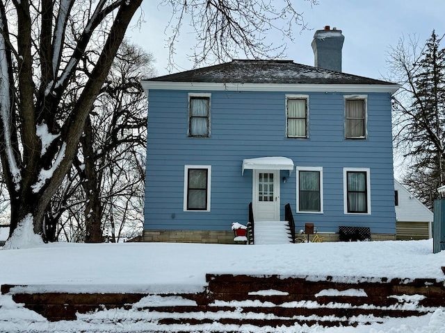 colonial inspired home with a chimney