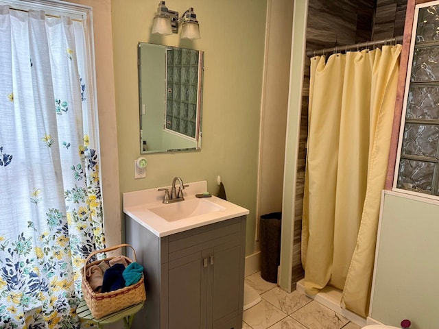 bathroom with vanity, marble finish floor, and a shower with shower curtain
