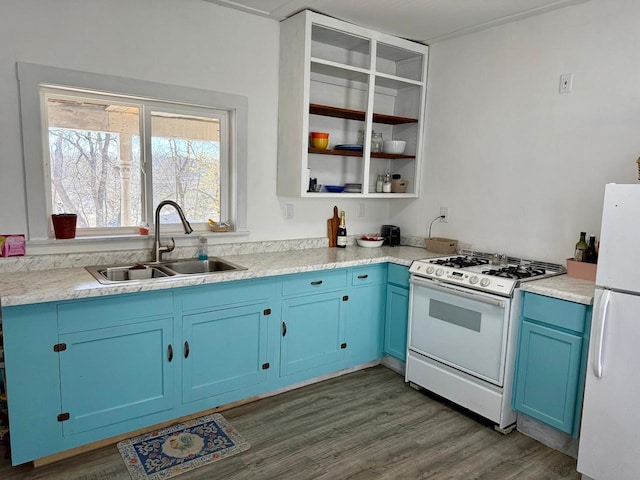 kitchen with blue cabinets, dark wood-style flooring, a sink, light countertops, and white appliances