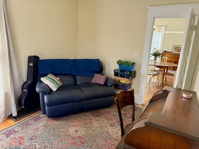 living area with wood finished floors and visible vents