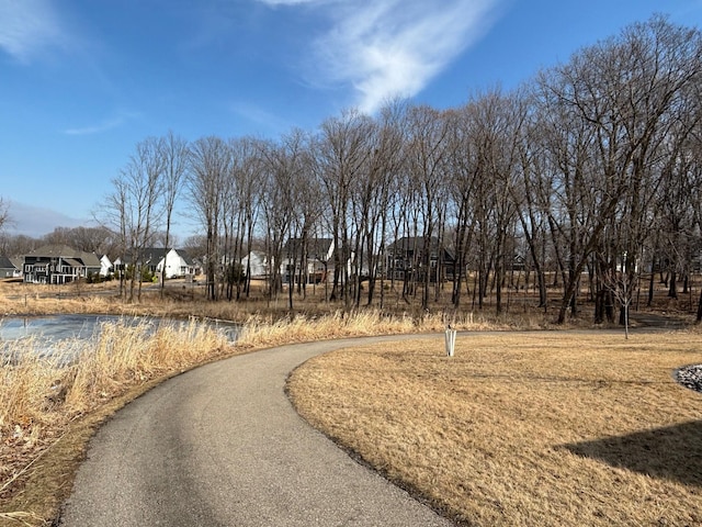 view of community with aphalt driveway