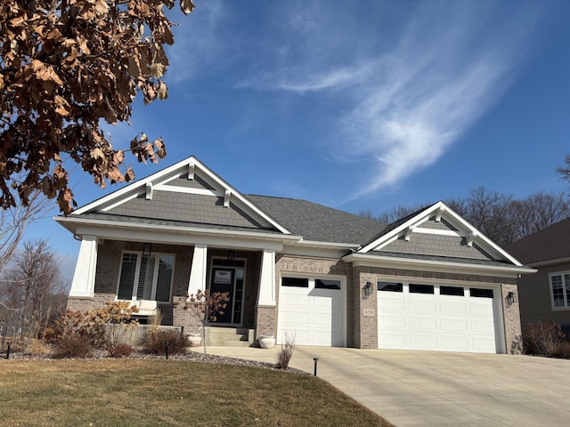 craftsman house with a porch, an attached garage, brick siding, concrete driveway, and a front yard