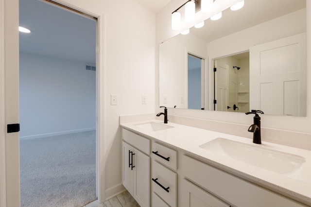 full bath with double vanity, visible vents, walk in shower, and a sink