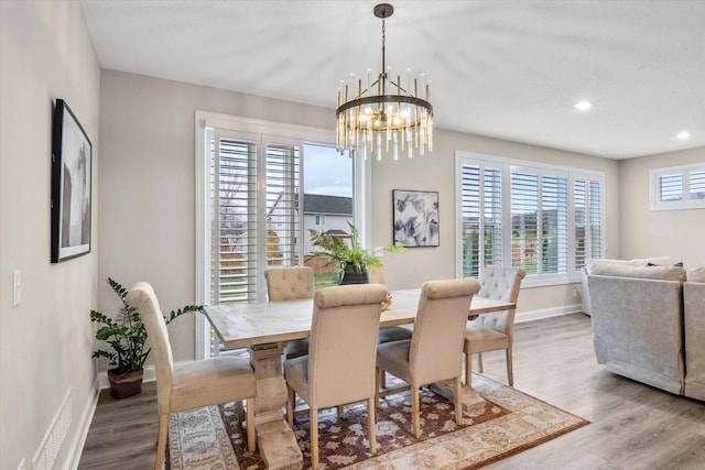 dining room featuring recessed lighting, visible vents, wood finished floors, a chandelier, and baseboards