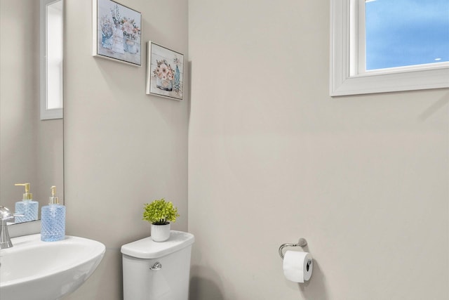 bathroom with toilet and a sink
