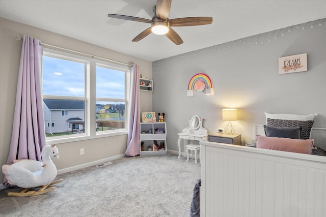 carpeted bedroom with baseboards, visible vents, and ceiling fan