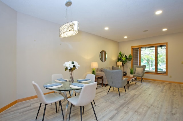 dining space featuring a notable chandelier, light wood finished floors, recessed lighting, and baseboards