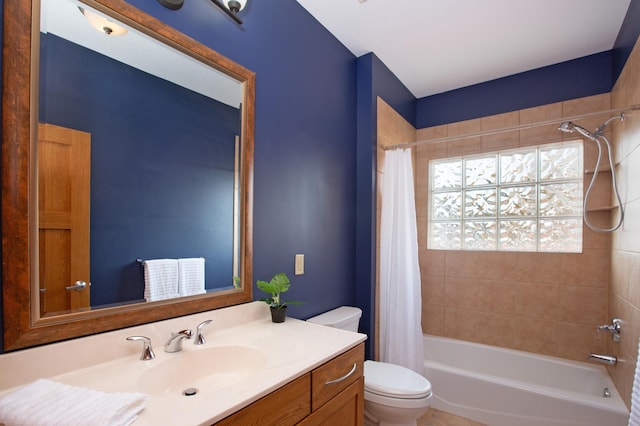 bathroom with shower / bathtub combination with curtain, toilet, and vanity