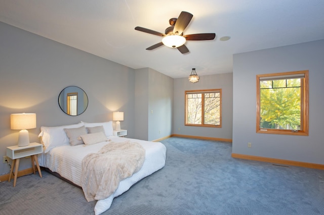 bedroom with carpet, ceiling fan, and baseboards