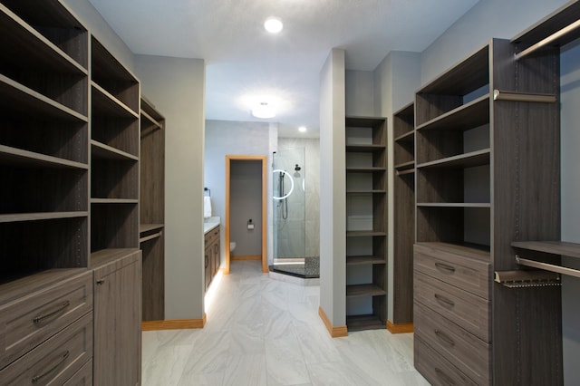 spacious closet with marble finish floor