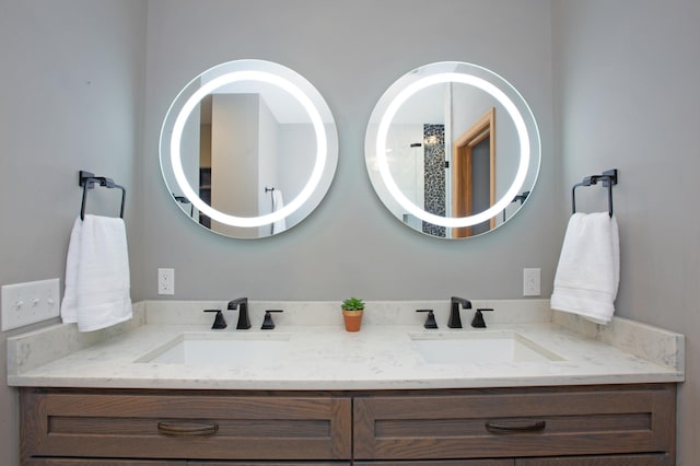 full bathroom featuring double vanity and a sink