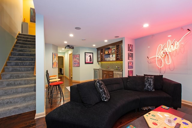 living room with baseboards, wood finished floors, stairs, indoor wet bar, and recessed lighting