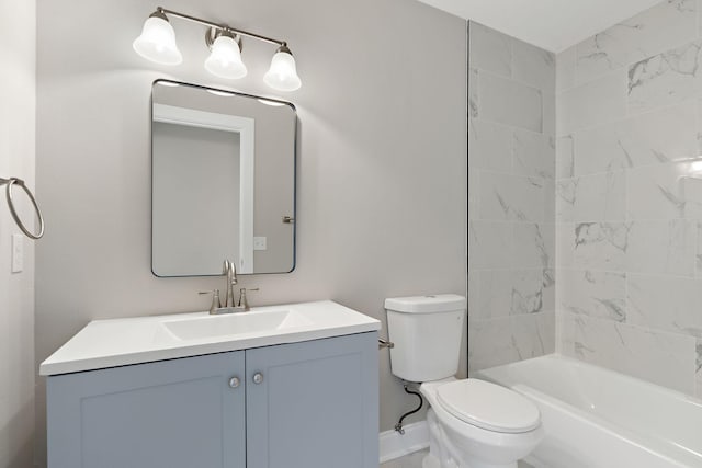 bathroom with baseboards, vanity, and toilet