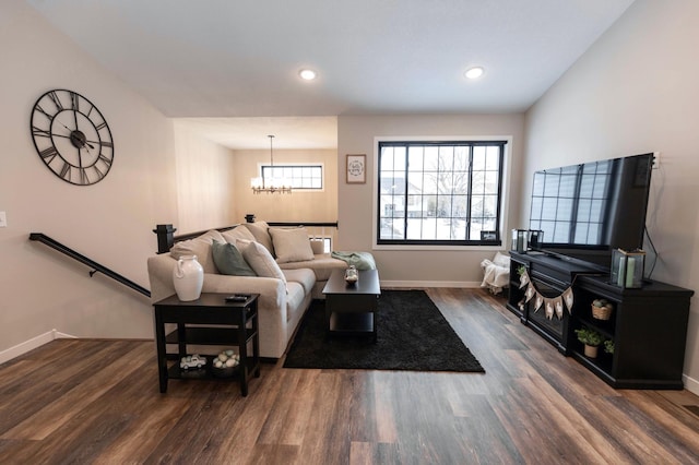 living area with recessed lighting, a notable chandelier, wood finished floors, and baseboards