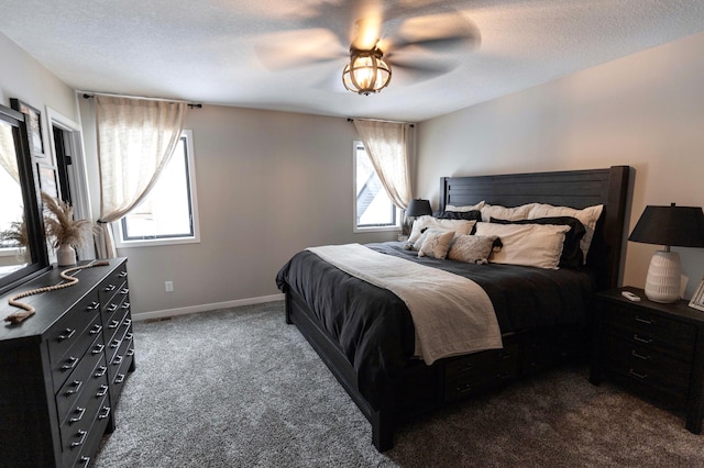 bedroom featuring baseboards, a textured ceiling, ceiling fan, and dark carpet