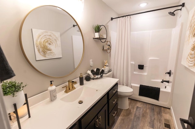 full bathroom featuring visible vents, shower / tub combo with curtain, toilet, wood finished floors, and vanity