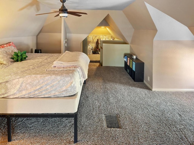 bedroom featuring vaulted ceiling, carpet flooring, visible vents, and baseboards