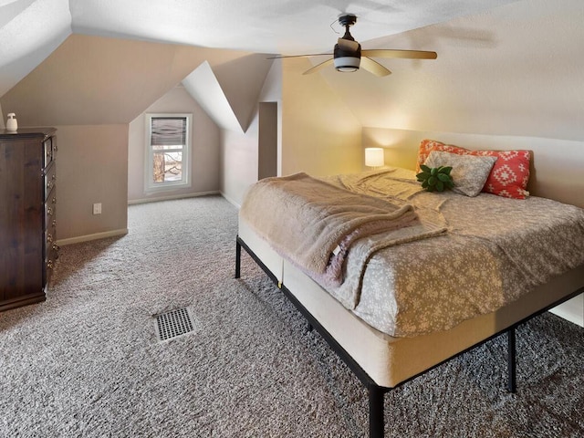 bedroom featuring lofted ceiling, baseboards, carpet floors, and a ceiling fan