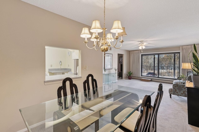 dining area with ceiling fan with notable chandelier, carpet, baseboards, and a textured ceiling