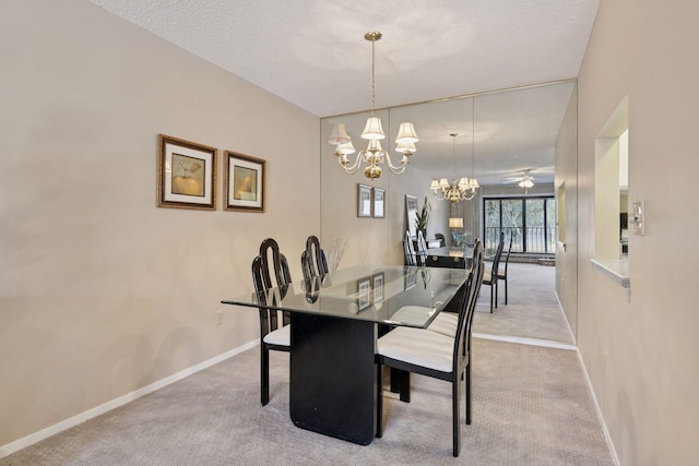 carpeted dining room featuring a chandelier, a textured ceiling, and baseboards