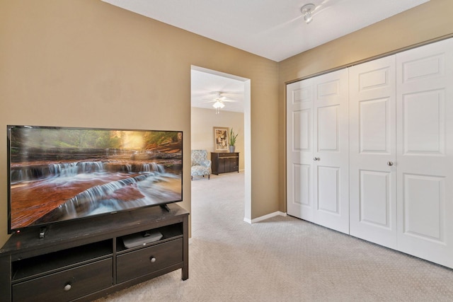 carpeted bedroom featuring a closet and baseboards