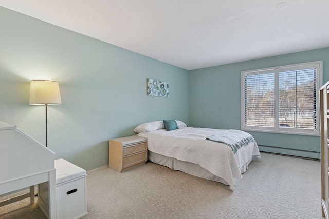 bedroom featuring light carpet, a baseboard heating unit, and baseboards