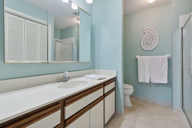 full bath with vanity, a shower stall, a textured ceiling, tile patterned floors, and toilet