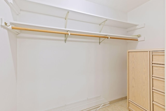 spacious closet featuring light tile patterned floors