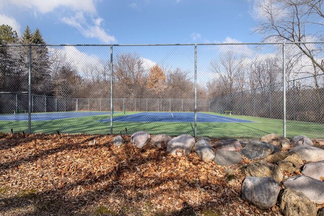 view of sport court featuring fence