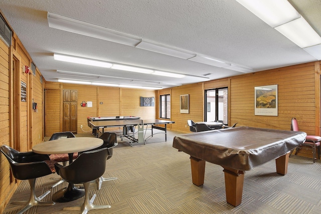 game room with carpet flooring, a textured ceiling, billiards, and wooden walls