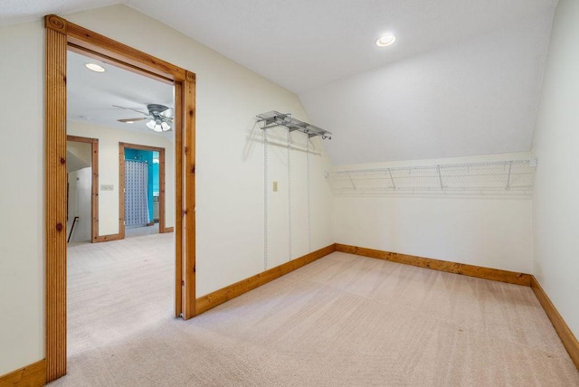 spacious closet featuring carpet, a ceiling fan, and vaulted ceiling