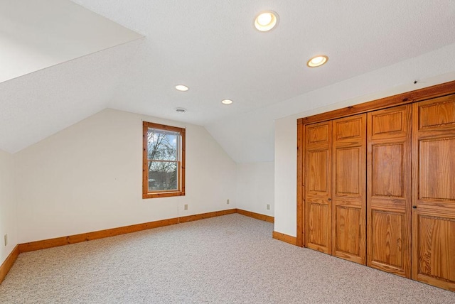 bonus room with baseboards, carpet floors, recessed lighting, vaulted ceiling, and a textured ceiling