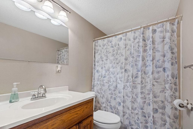 bathroom with vanity, toilet, a shower with curtain, and a textured ceiling