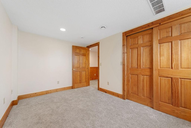 unfurnished bedroom with visible vents, baseboards, and carpet flooring