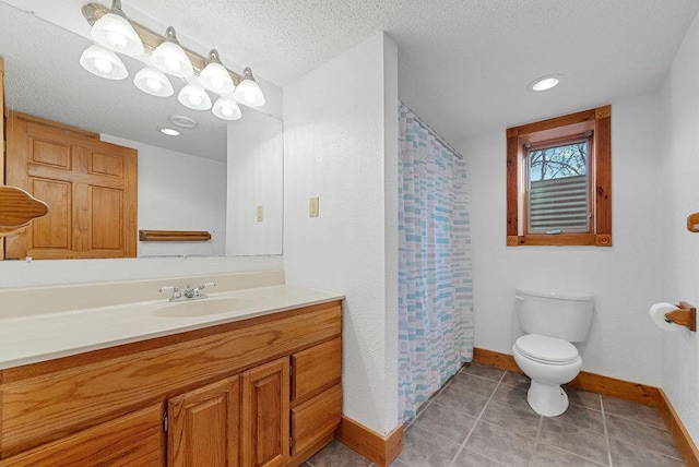 bathroom featuring tile patterned flooring, baseboards, toilet, vanity, and a textured ceiling