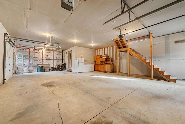 garage with a garage door opener and freestanding refrigerator