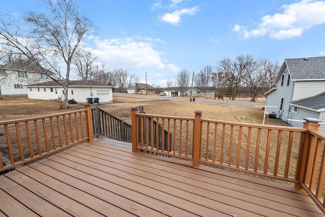 wooden deck featuring an outdoor structure and a residential view