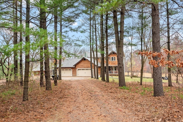 rustic home with a garage and driveway