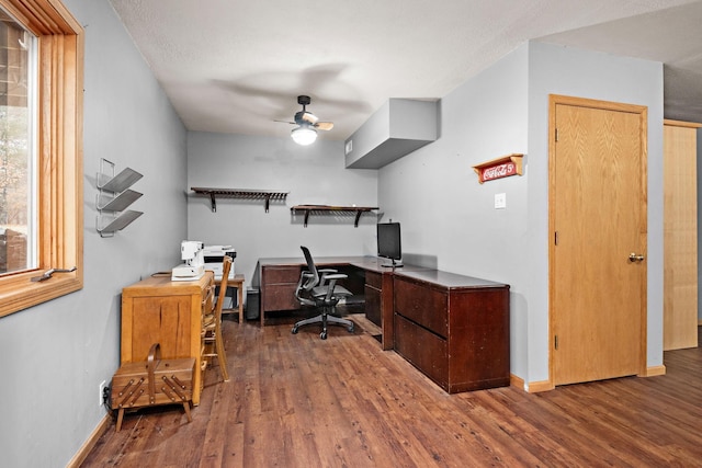 office area with a ceiling fan, baseboards, and wood finished floors