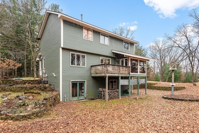 back of house featuring a sunroom and central AC