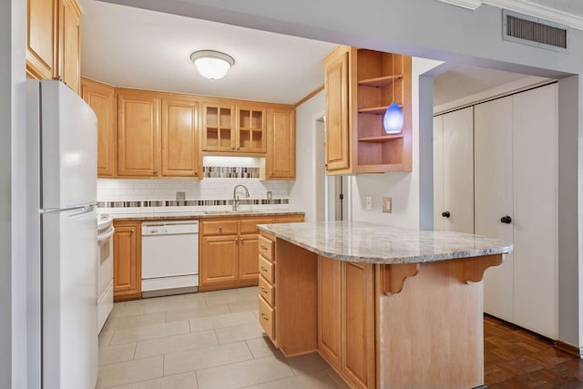 kitchen featuring white appliances, visible vents, a breakfast bar area, open shelves, and a sink