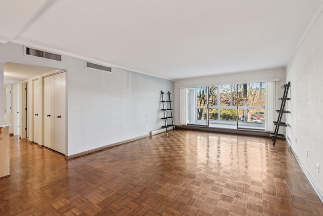 unfurnished room with crown molding, visible vents, and baseboards