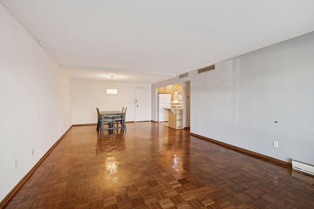 empty room with crown molding, visible vents, and baseboards