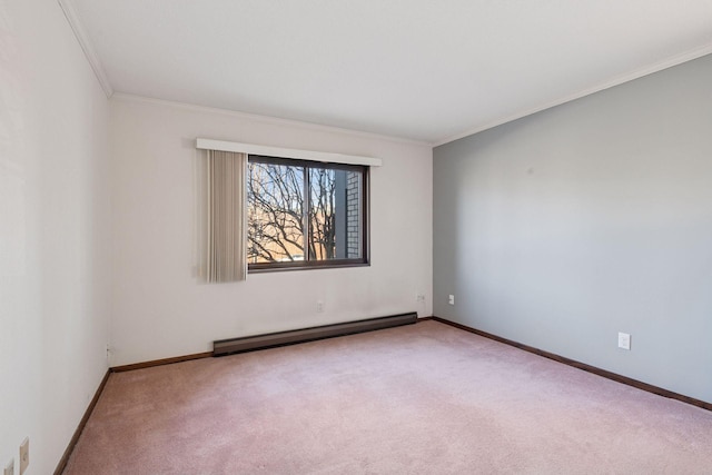 carpeted spare room with baseboards, baseboard heating, and crown molding