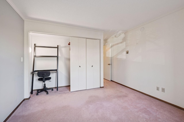 bedroom featuring carpet, a closet, ornamental molding, and baseboards