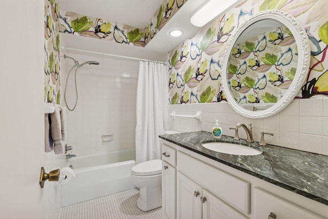 full bath with shower / bath combo, toilet, tile patterned flooring, vanity, and tile walls