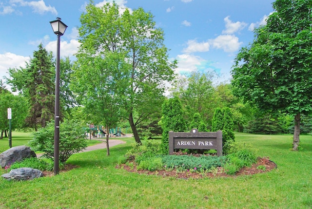 community sign featuring a lawn